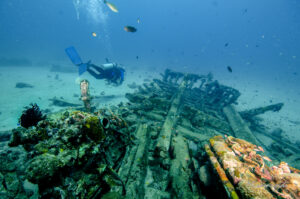 A diver exploring a shipwreck at Sabang Wrecks Puerto Galera
