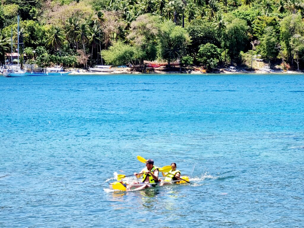 A couple paddling on a crystal kayak at Casalay Puerto Galera