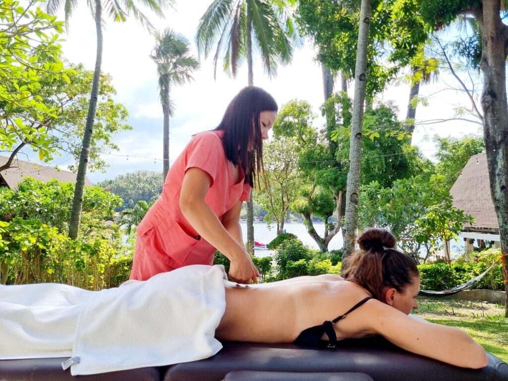 A guest getting a massage by the beach in Puerto Galera