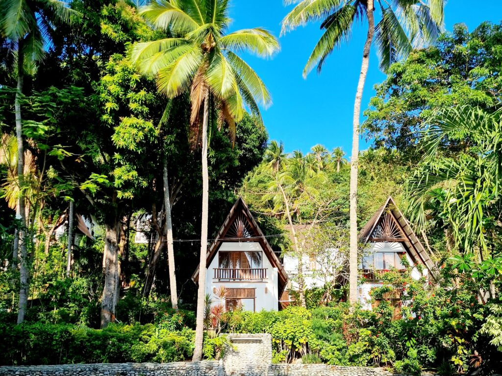 Villas surrounded by palm trees and gardens at Casalay Puerto Galera