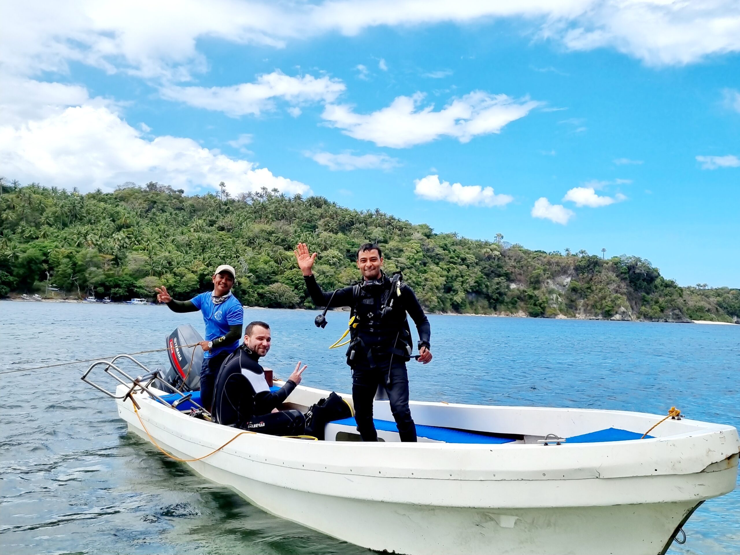 scuba instructor and student on a boat going out for a dive in Puerto Galera