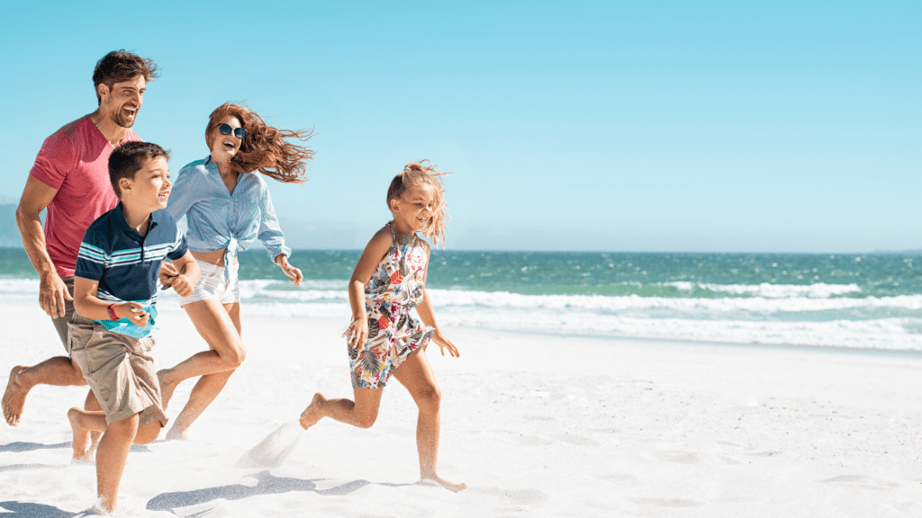 Family running around a beach